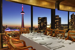 The Toronto skyline unfolds for diners at the romantic rooftop Westin Harbour Castle Toulà Restaurant