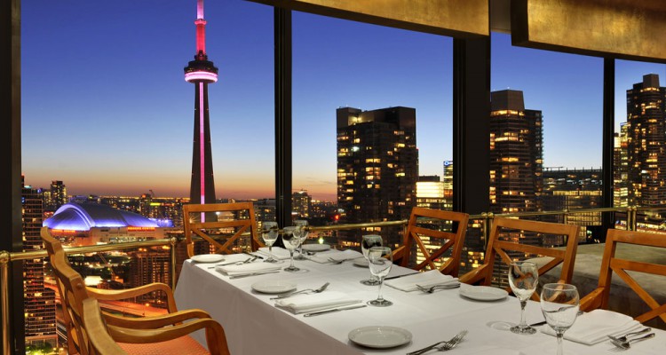 The Toronto skyline unfolds for diners at the romantic rooftop Westin Harbour Castle Toulà Restaurant