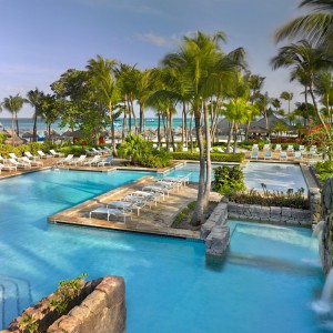 The pools are in a tropical park-like setting adjacent to the white sand beach 