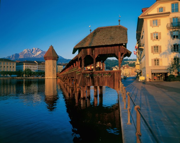 Lucerne on Lake Lucerne in central Switzerland and the historic Chapel Bridge and Mount Pilatus in the distance Swiss Tourism