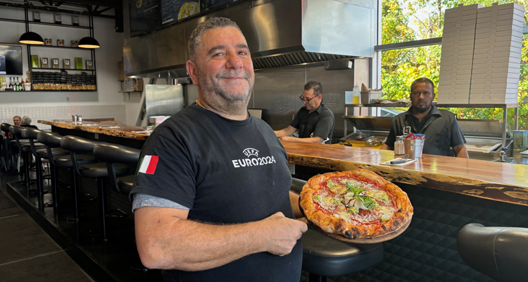 Lillo showcases one of his popular pizzas