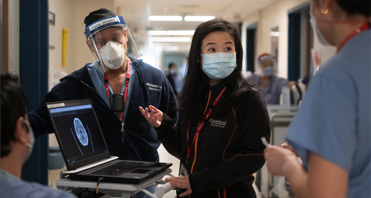 Stroke neurologist Dr. Amy Yu, centre, confers with colleagues about brain imaging at Sunnybrook in Toronto. Dr. Yu leads StrokeGoRed, a national network of research excellence.