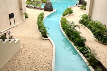 Secrets Tulum Resort & Beach Club - A ribbon-shaped pool flows into a cenote-inspired oasis, echoing Yucatán's underground rivers